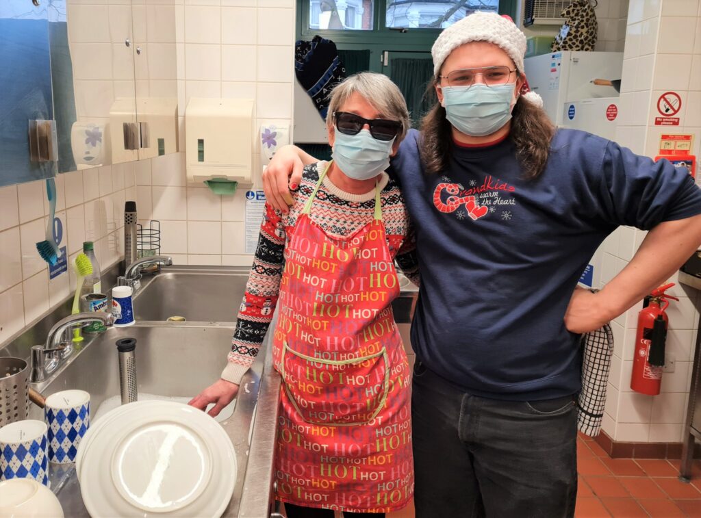 Two volunteers doing washing up in the kitchen
